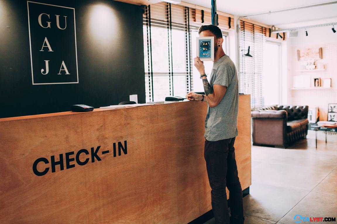 Guest standing at reception, hiding